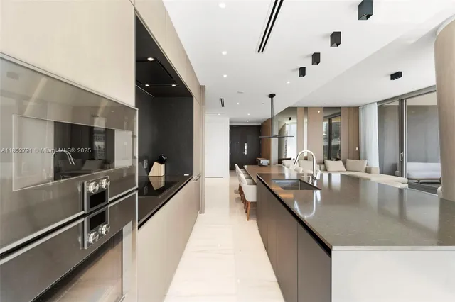 a large kitchen with kitchen island a large counter space