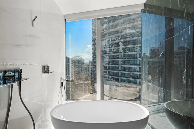 a bathroom with a bathtub and shower