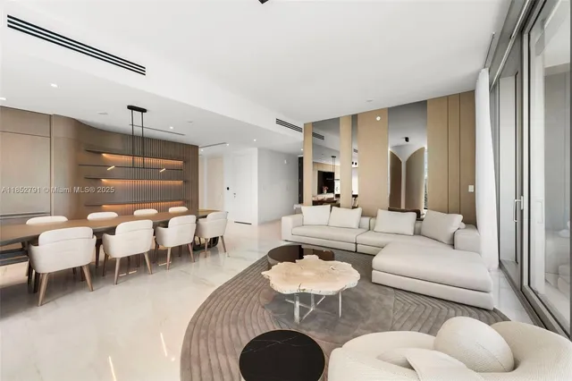 a living room with furniture a rug and a chandelier