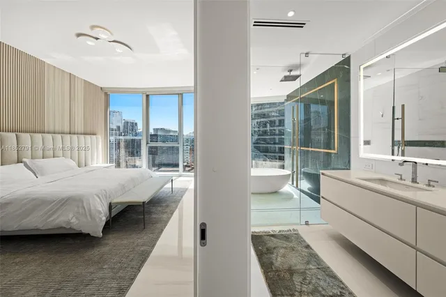 a bedroom with a large bed and a large window