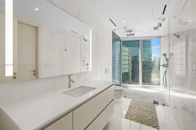 a spacious bathroom with a shower sink and mirror