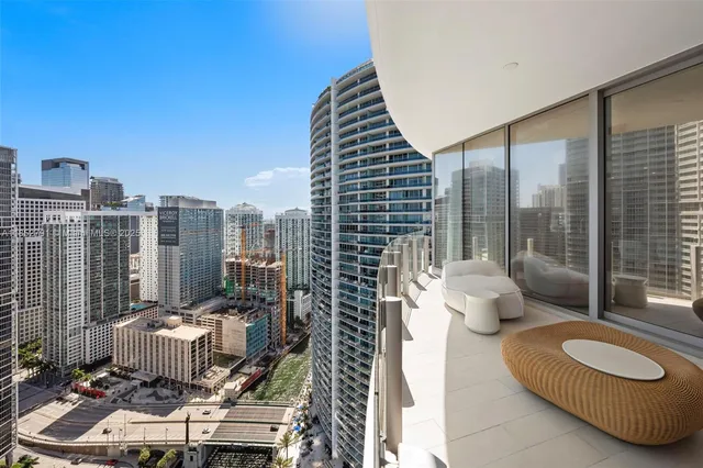 a building outdoor space with patio furniture and potted plants
