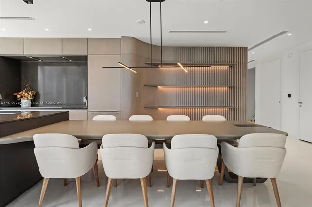 a kitchen with kitchen island granite countertop a table and chairs in it