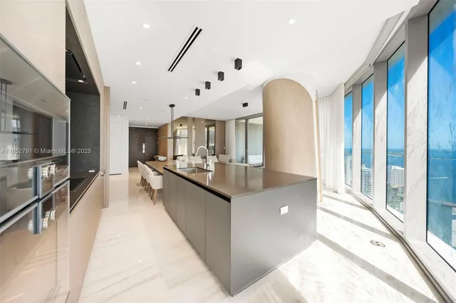 a large white kitchen with a large window