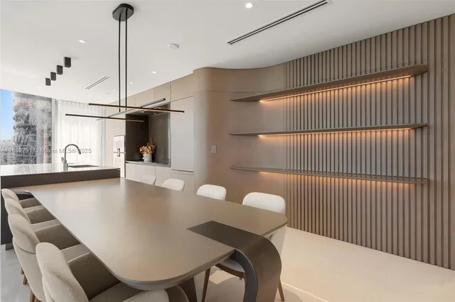 a kitchen with a table chairs and a chandelier