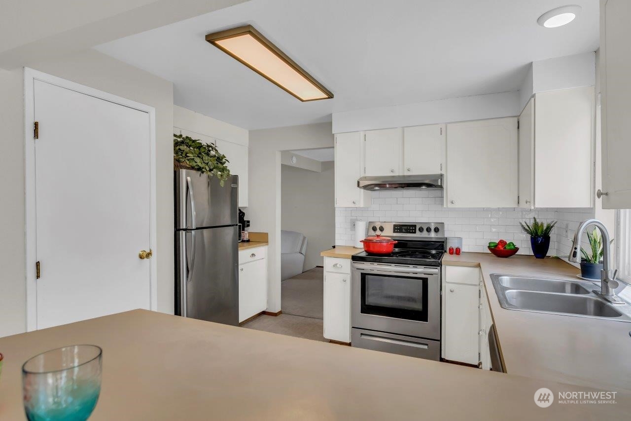 17043 159th Place Southeast Renton, WA 98058 - Photo 11 of 30 a kitchen with a stove and a refrigerator