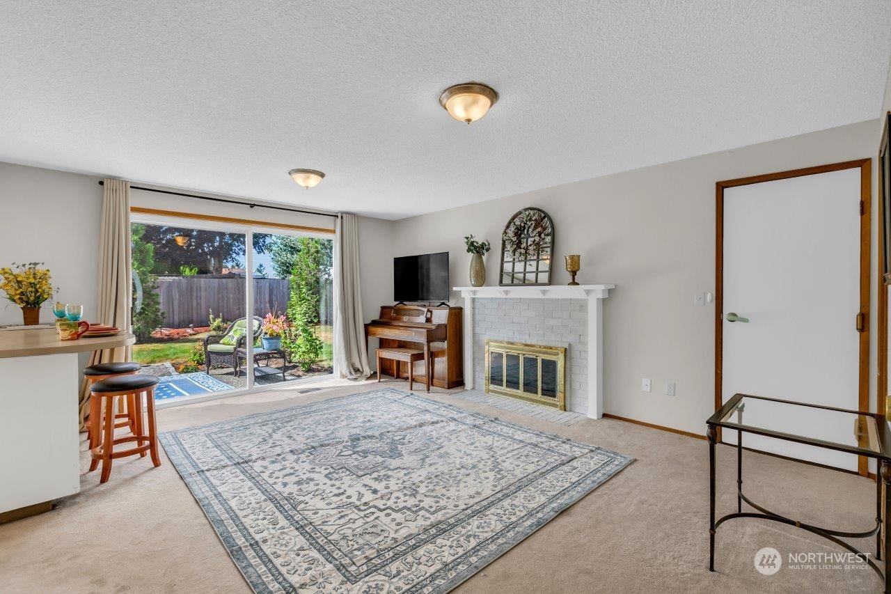 17043 159th Place Southeast Renton, WA 98058 - Photo 12 of 30 a living room with furniture and a fireplace