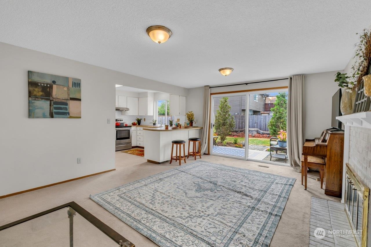 17043 159th Place Southeast Renton, WA 98058 - Photo 13 of 30 a living room with furniture and a table