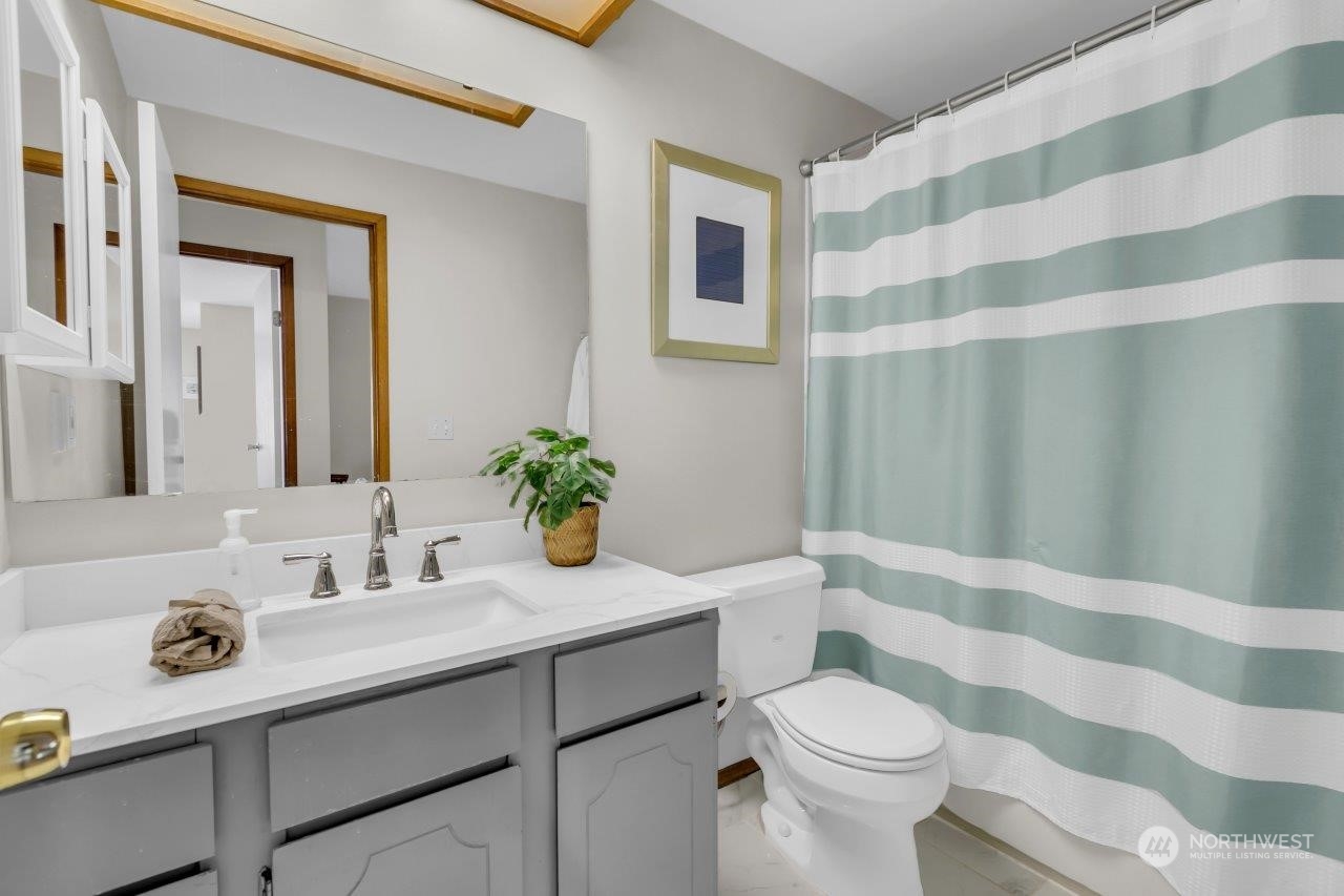 17043 159th Place Southeast Renton, WA 98058 - Photo 19 of 30 a bathroom with a sink toilet and shower