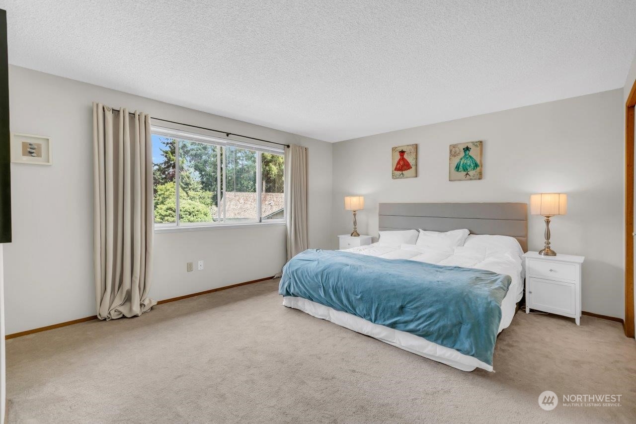17043 159th Place Southeast Renton, WA 98058 - Photo 21 of 30 a spacious bedroom with a bed and a window