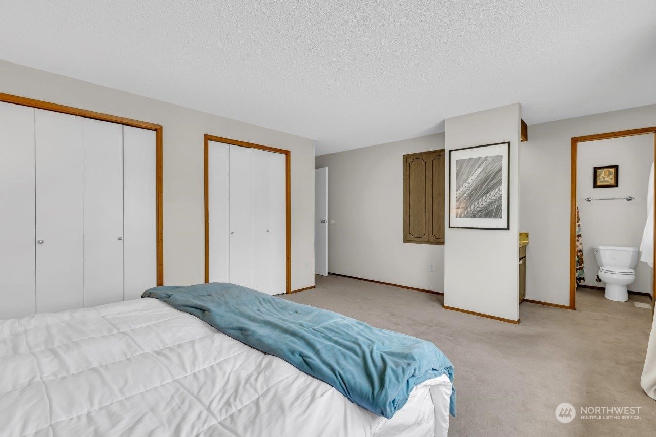 17043 159th Place Southeast Renton, WA 98058 - Photo 22 of 30 a bedroom with a bed and cabinets