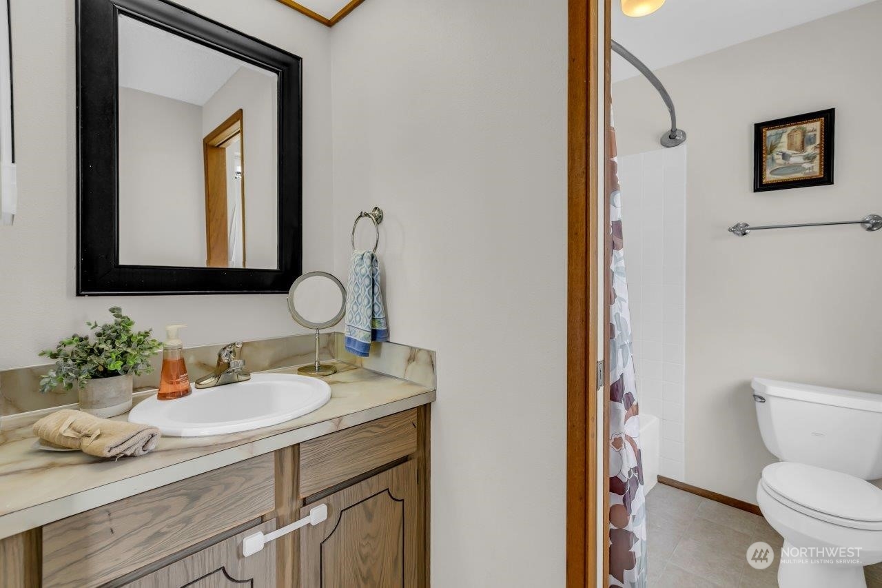 17043 159th Place Southeast Renton, WA 98058 - Photo 23 of 30 a bathroom with a toilet sink and mirror