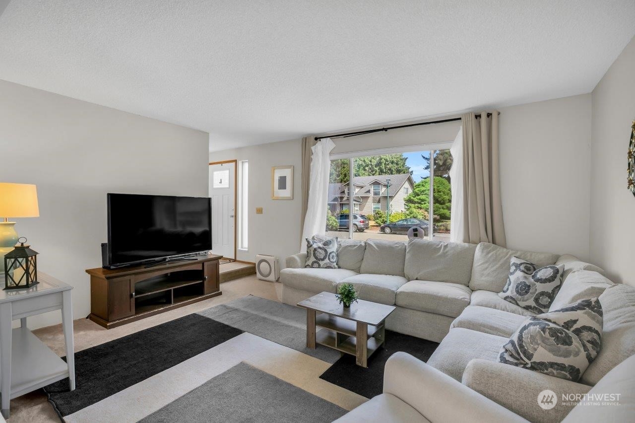17043 159th Place Southeast Renton, WA 98058 - Photo 7 of 30 a living room with furniture and a flat screen tv