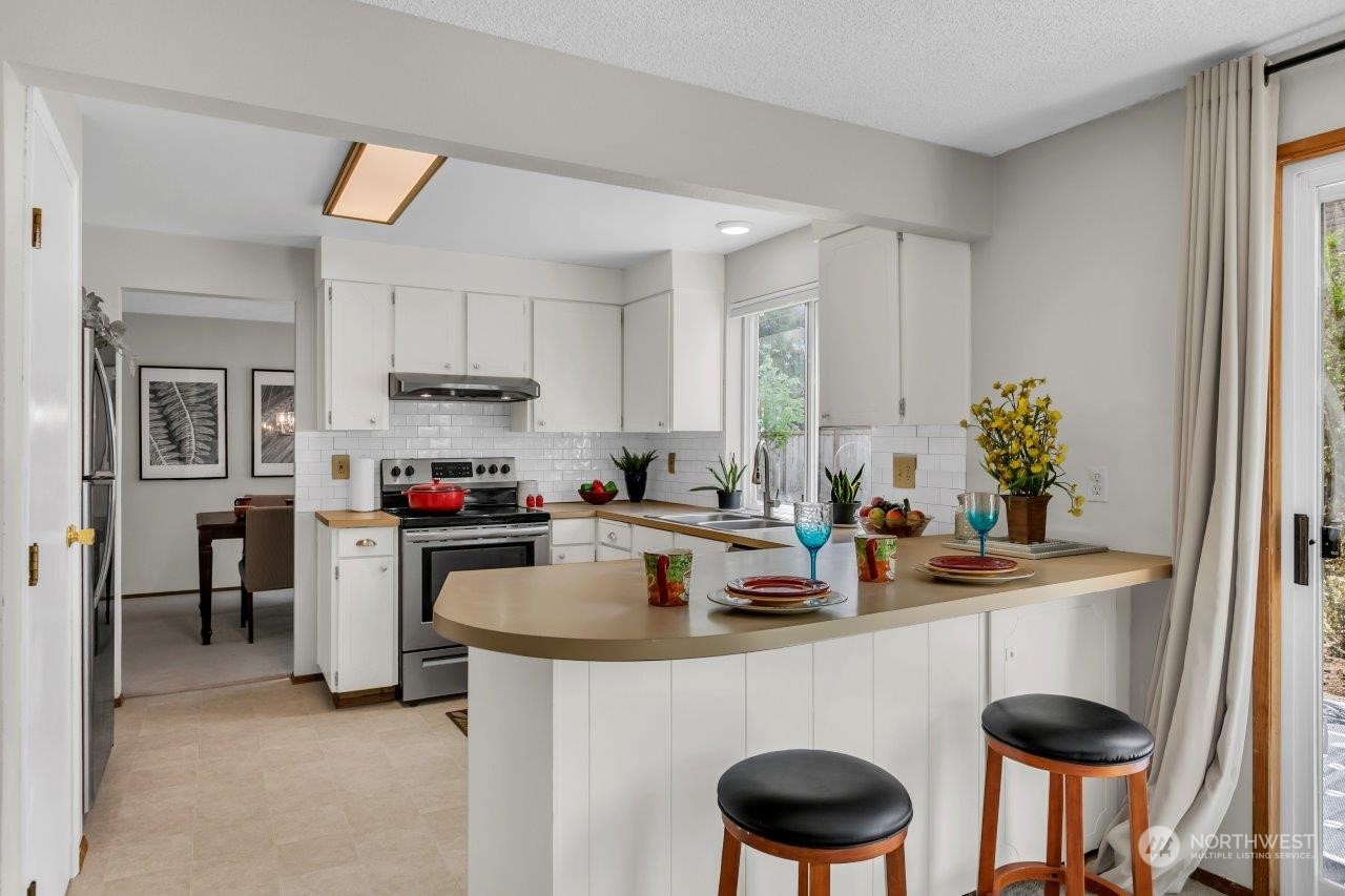 17043 159th Place Southeast Renton, WA 98058 - Photo 9 of 30 a kitchen with a table and chairs in it