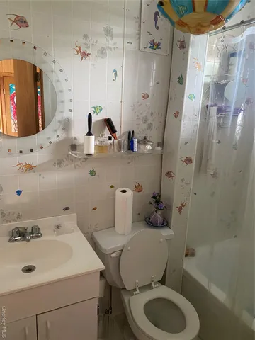 a bathroom with a sink toilet mirror and shower