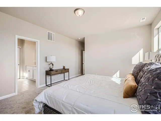 a bedroom with a bed and a table