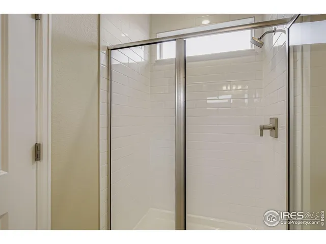 a bathroom with a glass shower door
