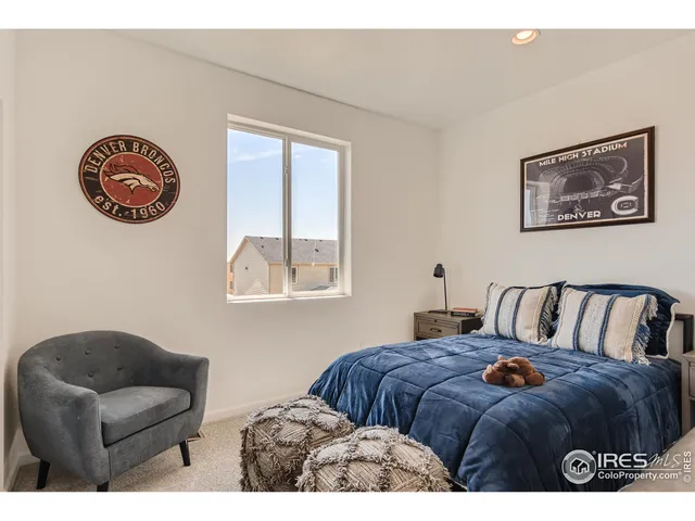 a bedroom with a bed and a couch