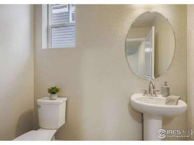 a bathroom with a sink mirror and toilet