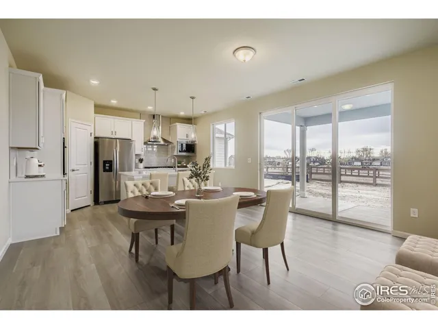 a view of a dining room and livingroom with furniture wooden floor