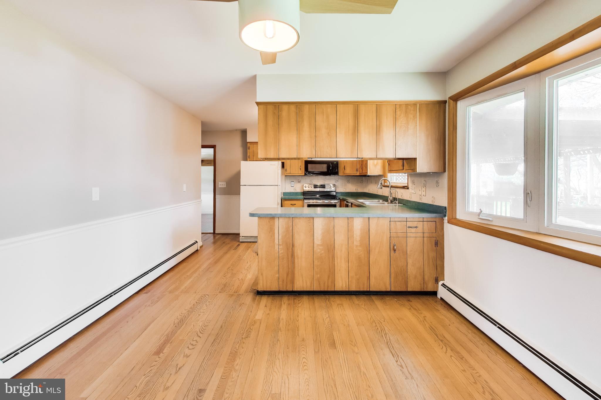 3904 Overlook Lane Monrovia, MD 21770 - Photo 11 of 54 a view of a kitchen with wooden floor and stainless steel appliances
