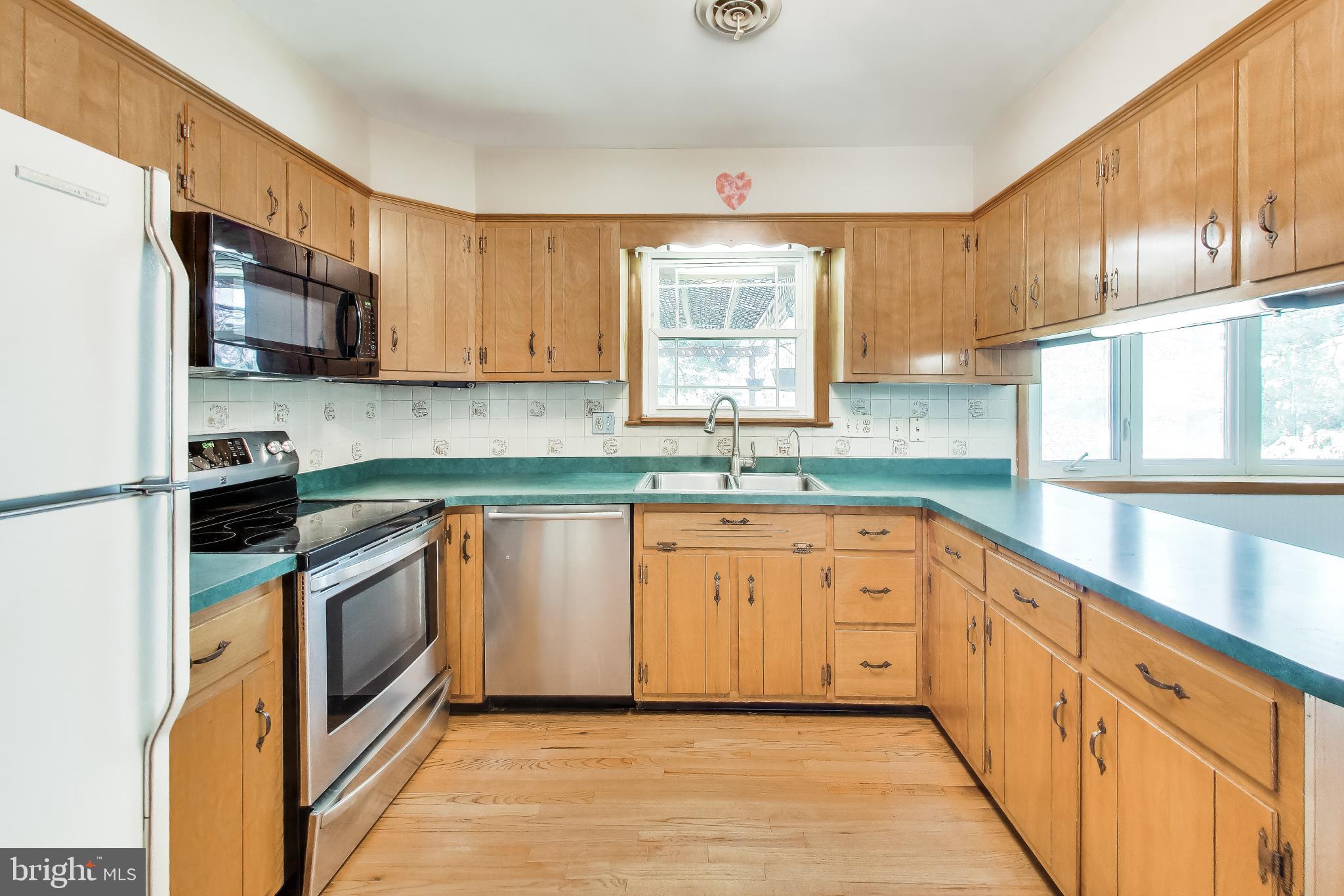 3904 Overlook Lane Monrovia, MD 21770 - Photo 13 of 54 a kitchen with stainless steel appliances granite countertop a sink and a stove