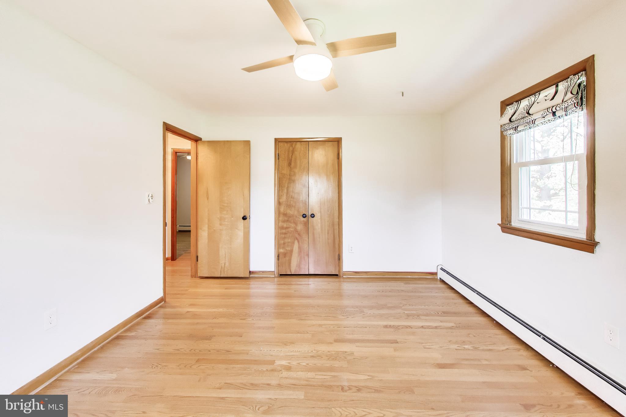 3904 Overlook Lane Monrovia, MD 21770 - Photo 19 of 54 a view of an empty room with window and wooden floor
