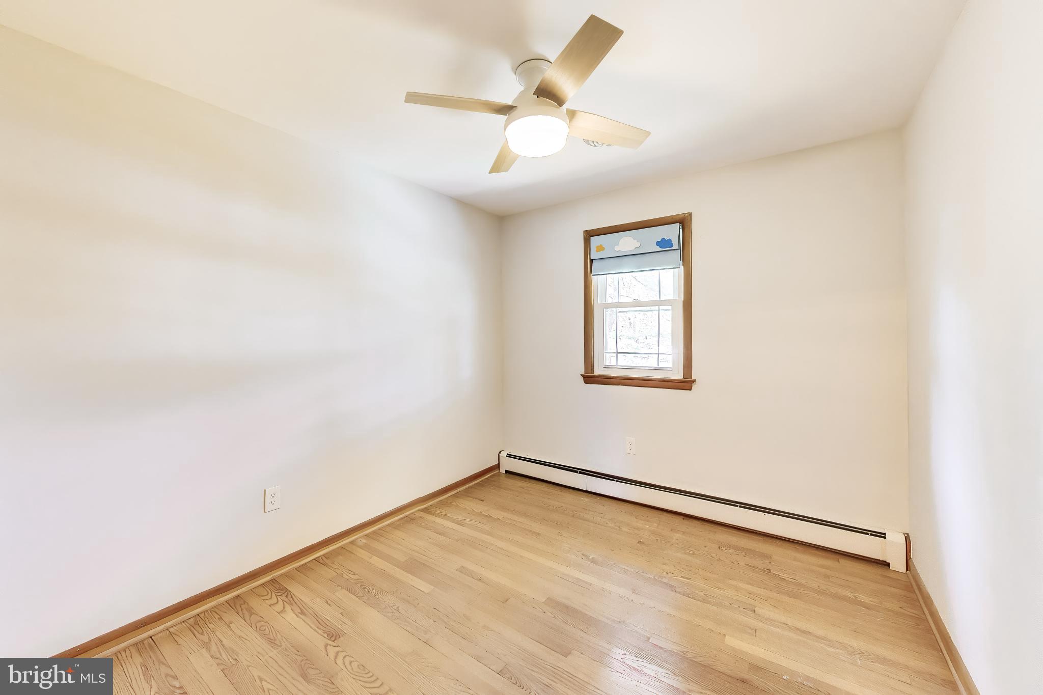 3904 Overlook Lane Monrovia, MD 21770 - Photo 24 of 54 an empty room with a window and a ceiling fan