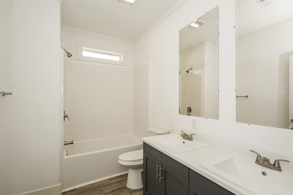 2003 East Overton Road Dallas, TX 75216 - Photo 15 of 16 a bathroom with a sink a toilet and shower