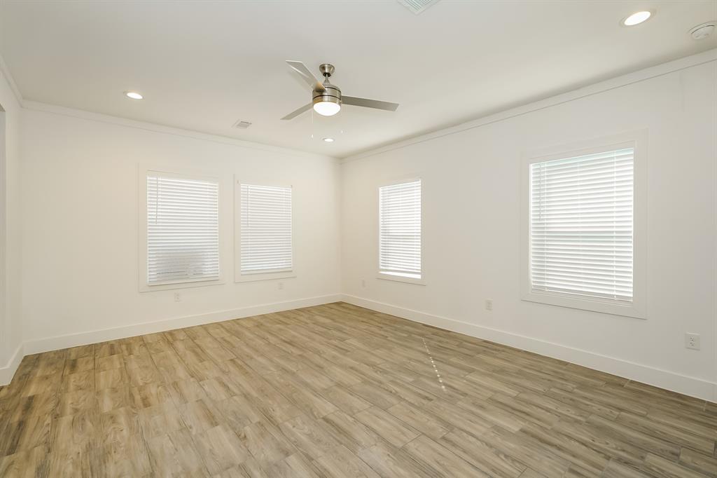 2003 East Overton Road Dallas, TX 75216 - Photo 3 of 16 a view of an empty room with wooden floor and a window