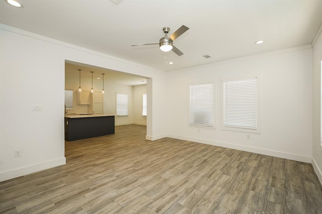 2003 East Overton Road Dallas, TX 75216 - Photo 4 of 16 an empty room with wooden floor and windows