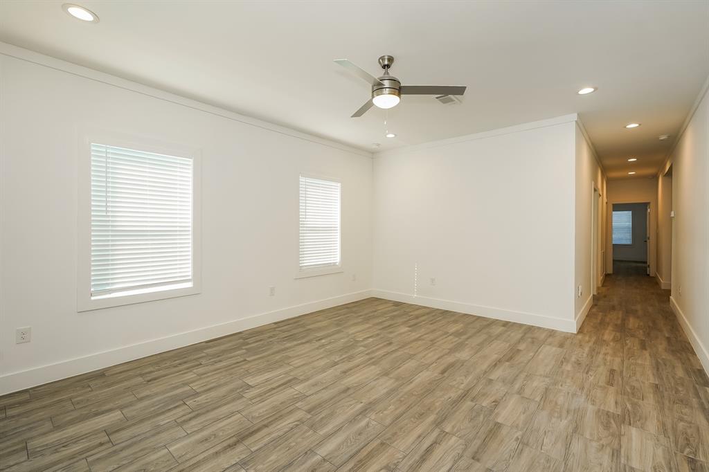 2003 East Overton Road Dallas, TX 75216 - Photo 5 of 16 a view of an empty room with wooden floor and a window
