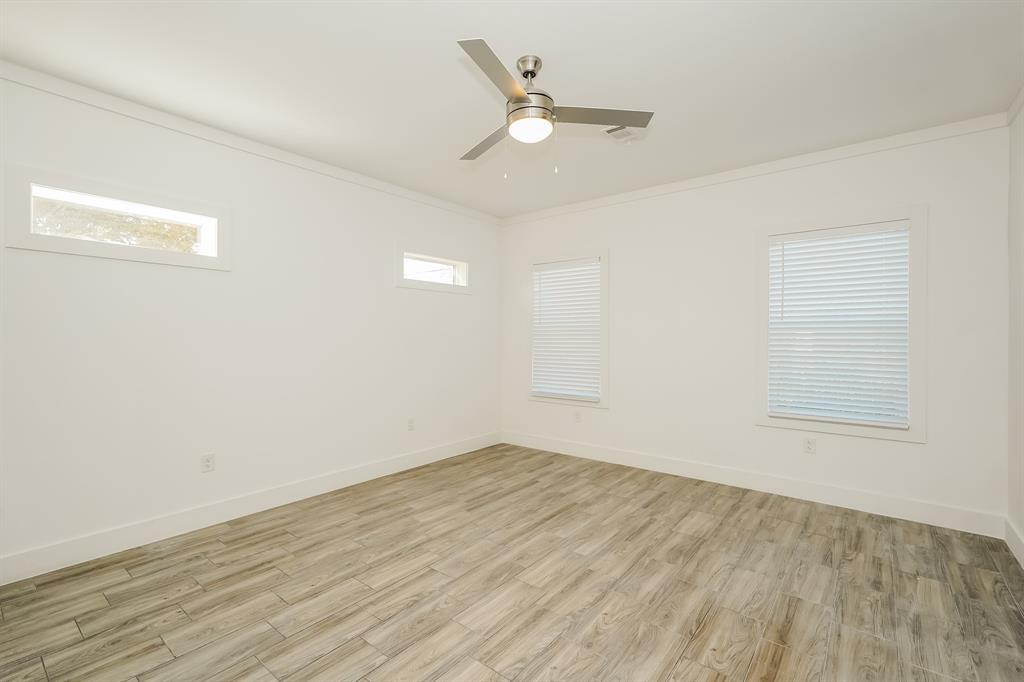 2003 East Overton Road Dallas, TX 75216 - Photo 9 of 16 an empty room with wooden floor and windows