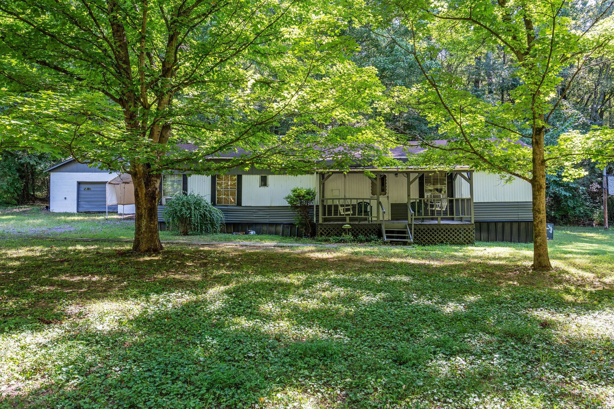 1046 Cemetery Road Ashland City, TN 37015 - Photo 4 of 15 a front view of a house with a garden