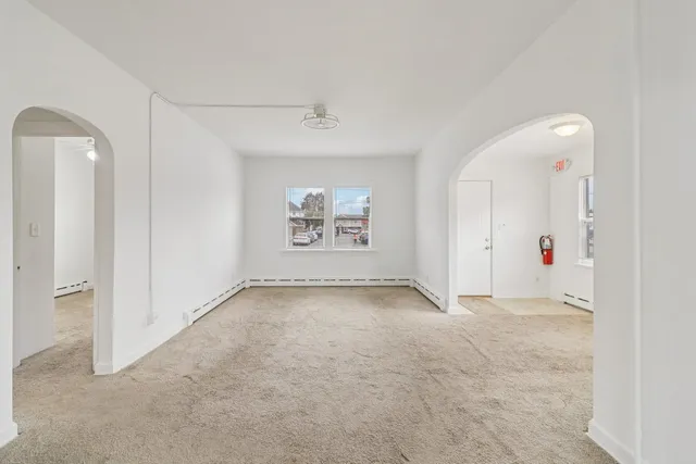 an empty room with a empty space and windows