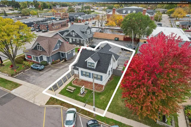 an aerial view of a house with a garden and lake view