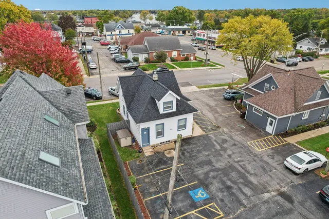 an aerial view of a house with garden space and street view