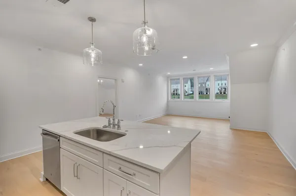 a kitchen with a sink chandelier and stove