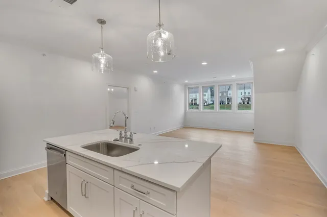 a kitchen with a sink chandelier and stove