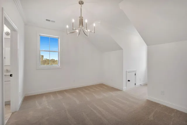 a view of an empty room with chandelier
