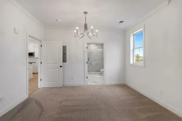 a view of an empty room with window and cabinet