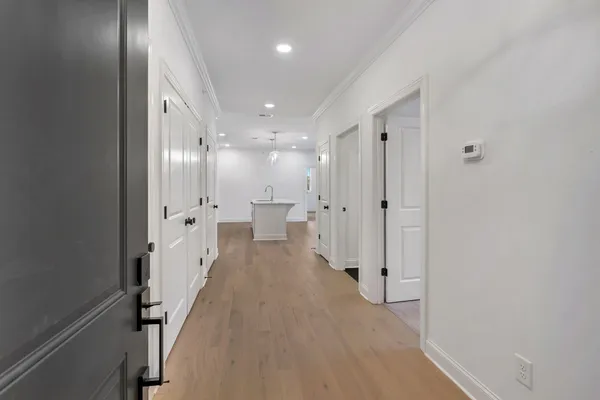 a view of a hallway with wooden floor