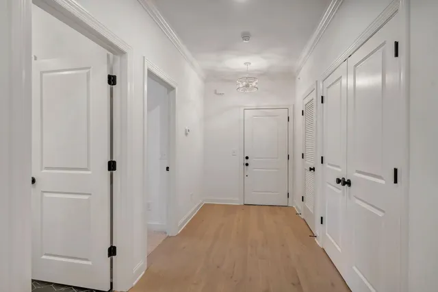 a view of a hallway with wooden floor