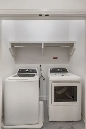 a view of washer and dryer with kitchen racks