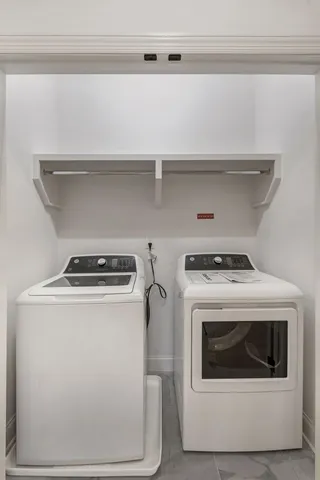 a view of washer and dryer with kitchen racks