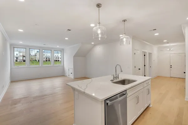 a kitchen with a sink and chandelier