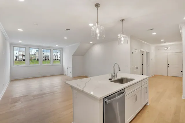 a kitchen with a sink and chandelier