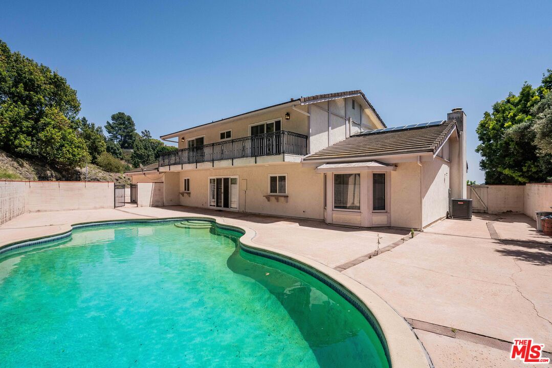 1181 Somera Road Los Angeles, CA 90077 - Photo 29 of 40 a front view of a house with a yard and garage