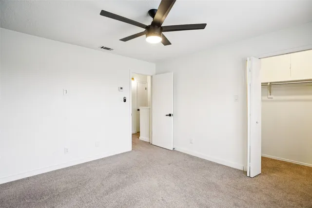a view of a room with a ceiling fan