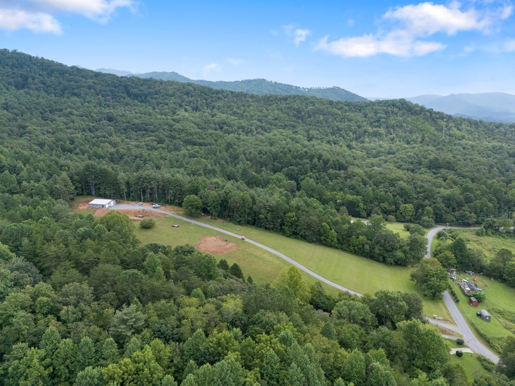 115 Ash Loop Road Hayesville, NC 28904 - Photo 24 of 37 a view of a green field with mountains in the background